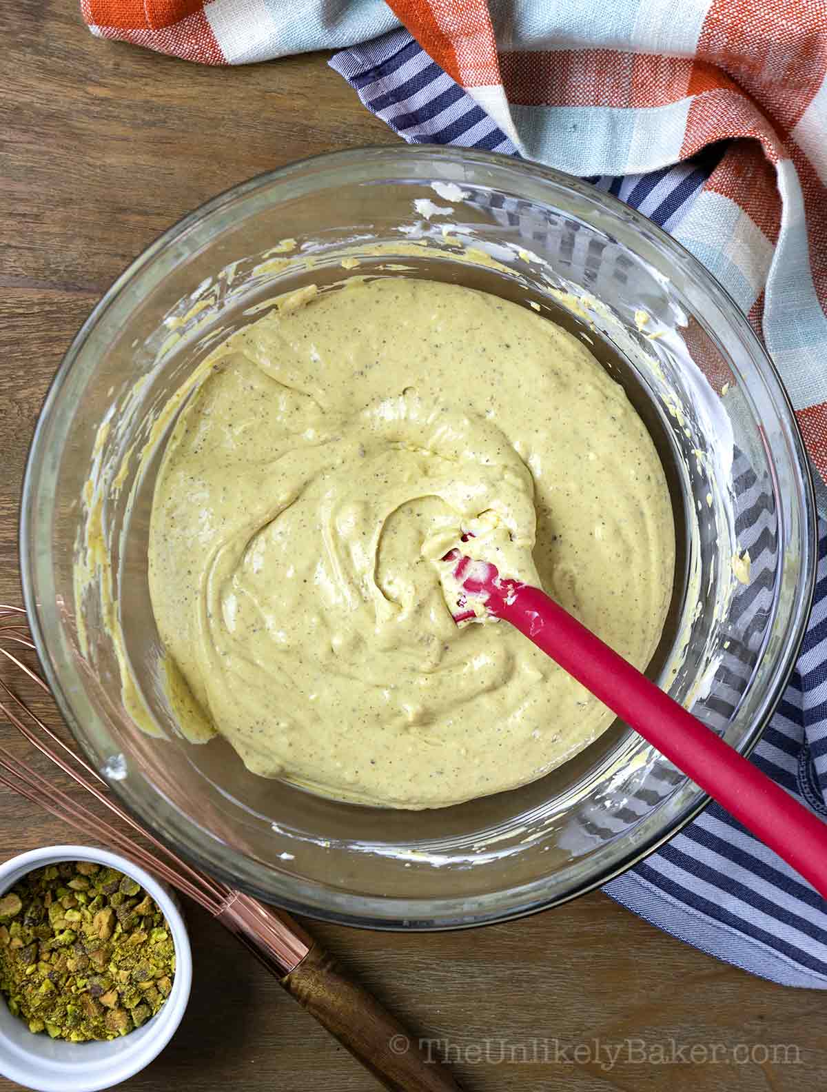 Pistachio white chocolate cheesecake batter in bowl.