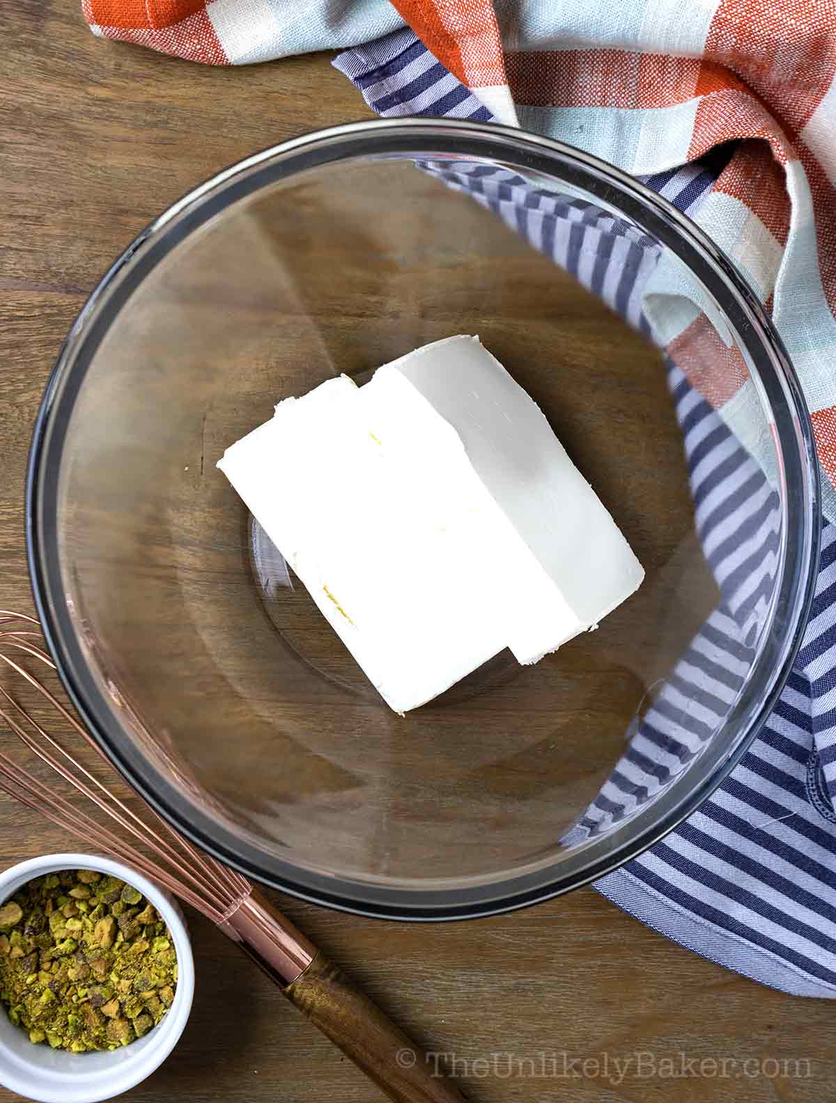 Blocks of cream cheese in a bowl.