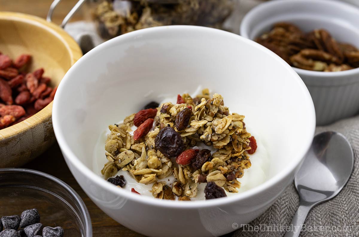 Granola with maple syrup sprinkled on Greek yogurt.