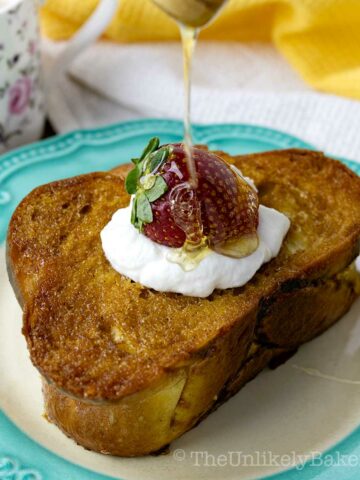 Honey butter toast topped with yogurt and strawberry.