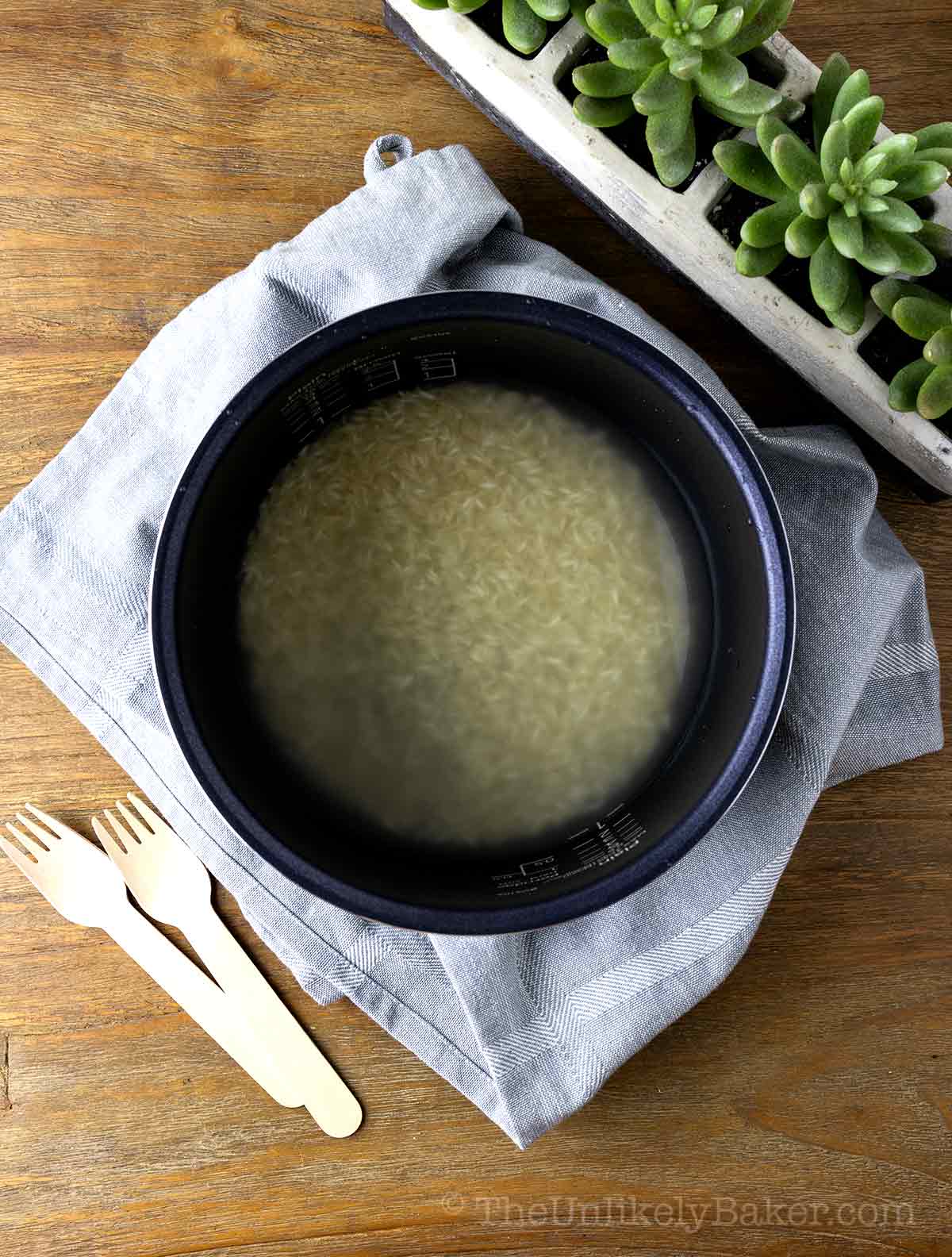 Rice with water in a rice cooker.