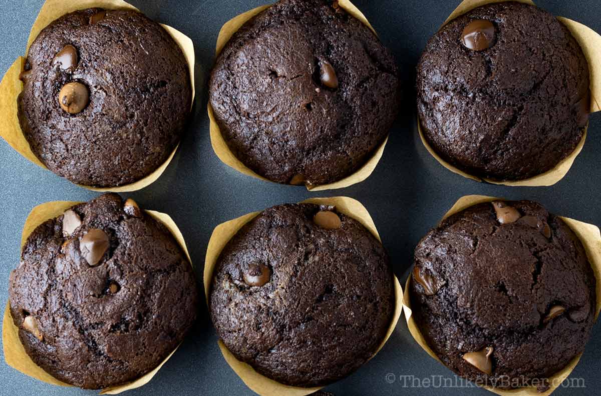 Olympic Village copycat chocolate muffins in a muffin tin.