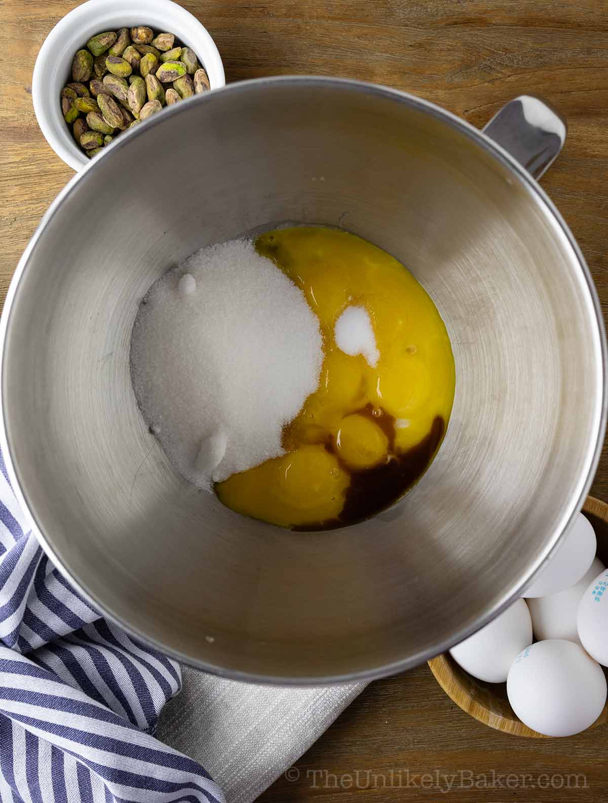 Egg yolks and sugar in a bowl.