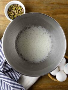 Foamy egg whites in a bowl.