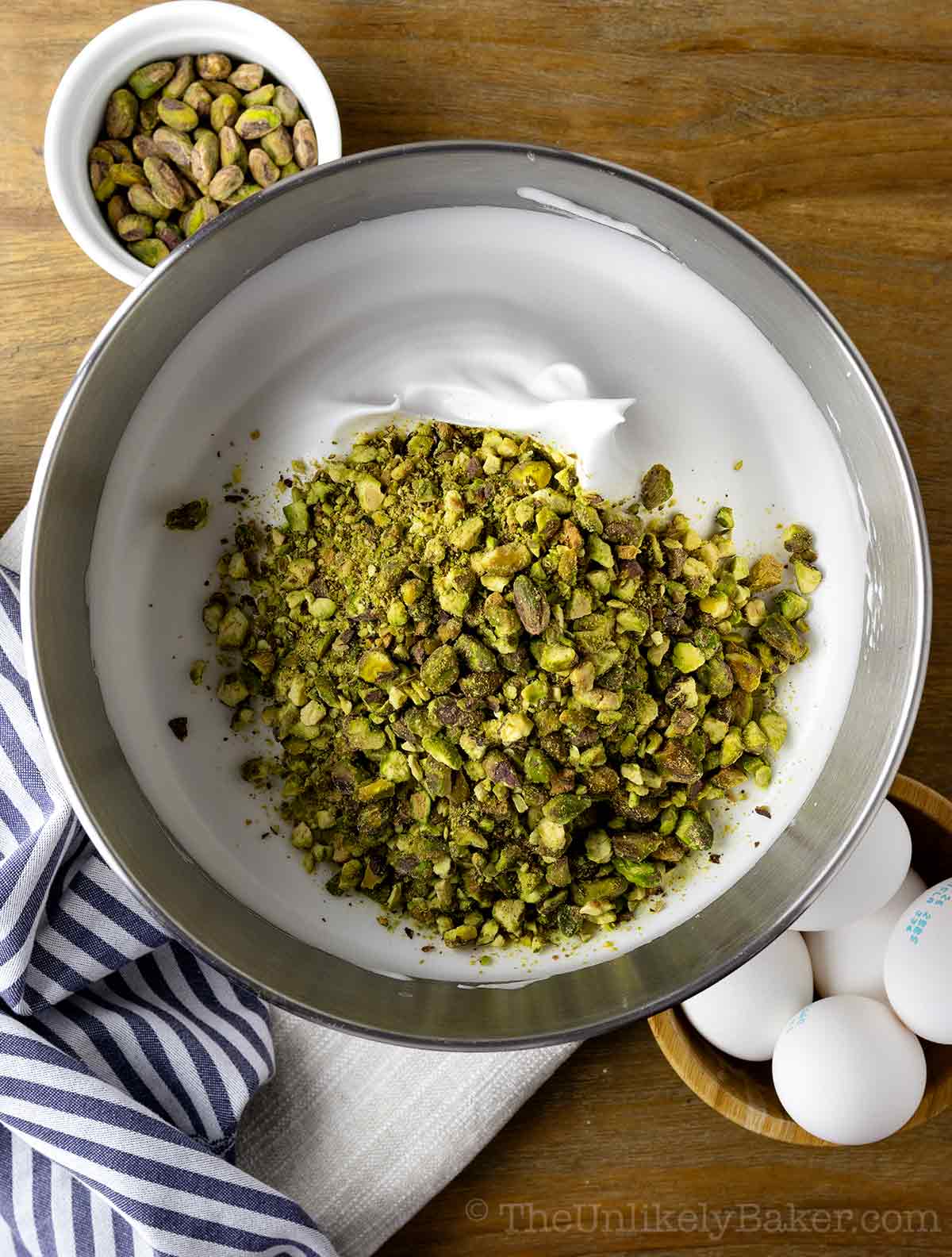 Chopped pistachios added to egg whites.