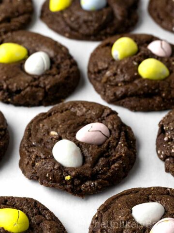 Freshly baked mini egg cookies on a pan.