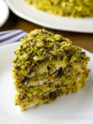 A slice of pistachio sans rival on a plate.