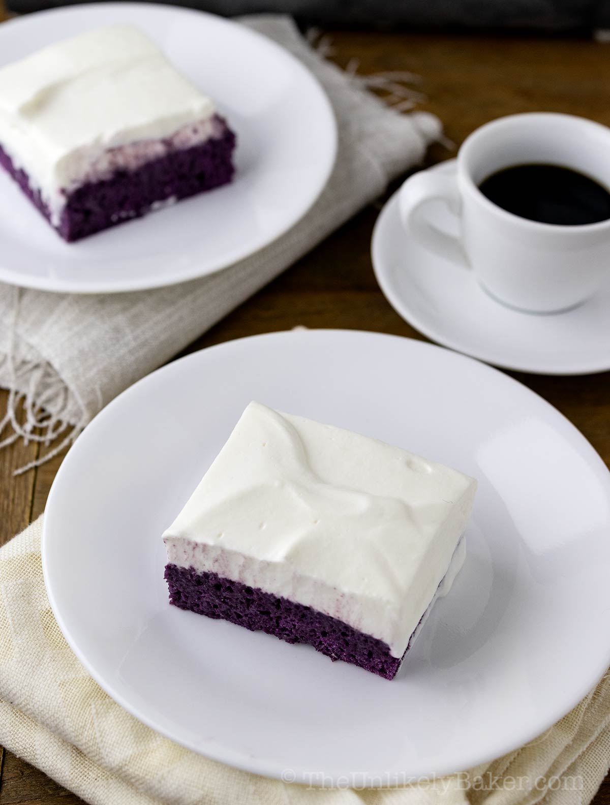 Slice of ube tres leches cake with coffee.