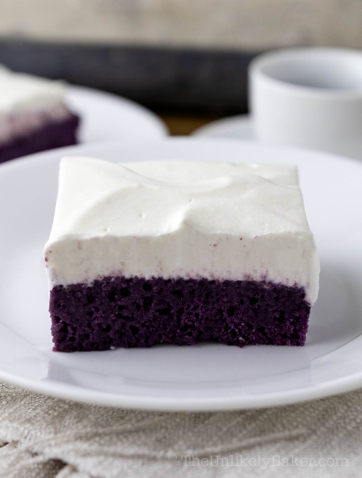 A slice of tres leches with ube.