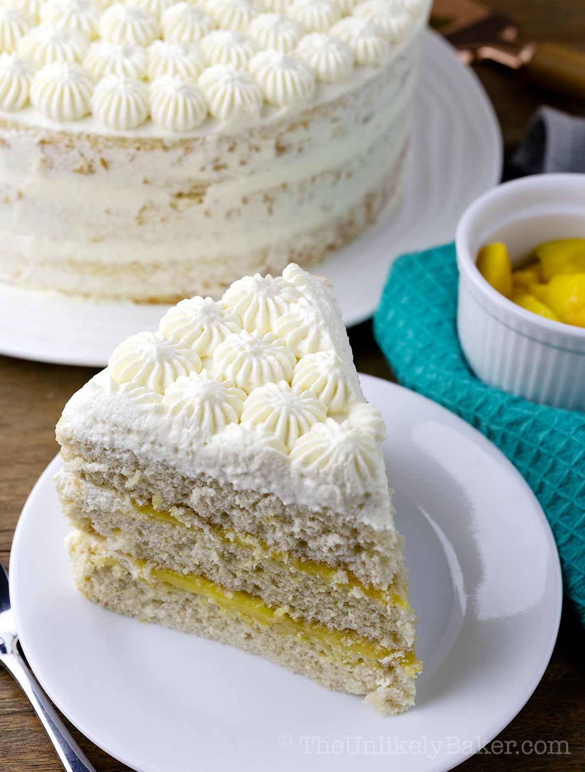 A slice of mango cake with cream.