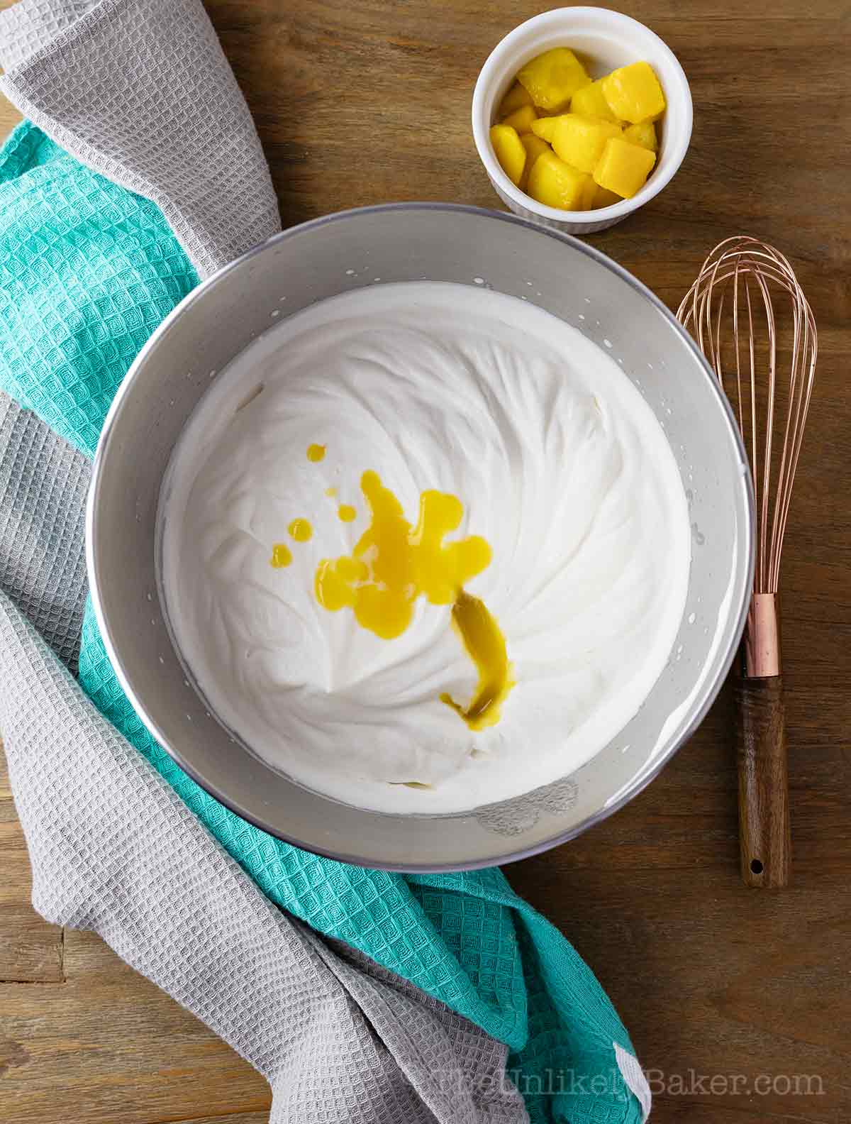 Mango puree added to whipped cream.