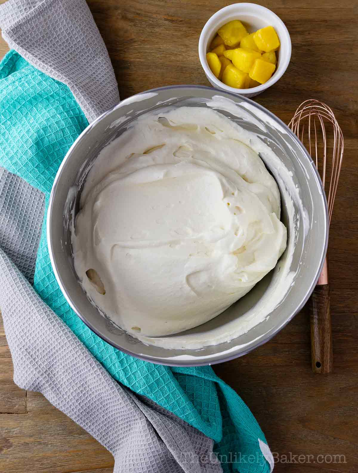 Whipped mango cream frosting in a bowl.