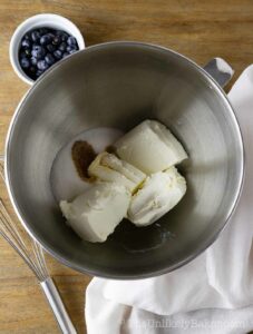 Cream cheese and sugar in a bowl.