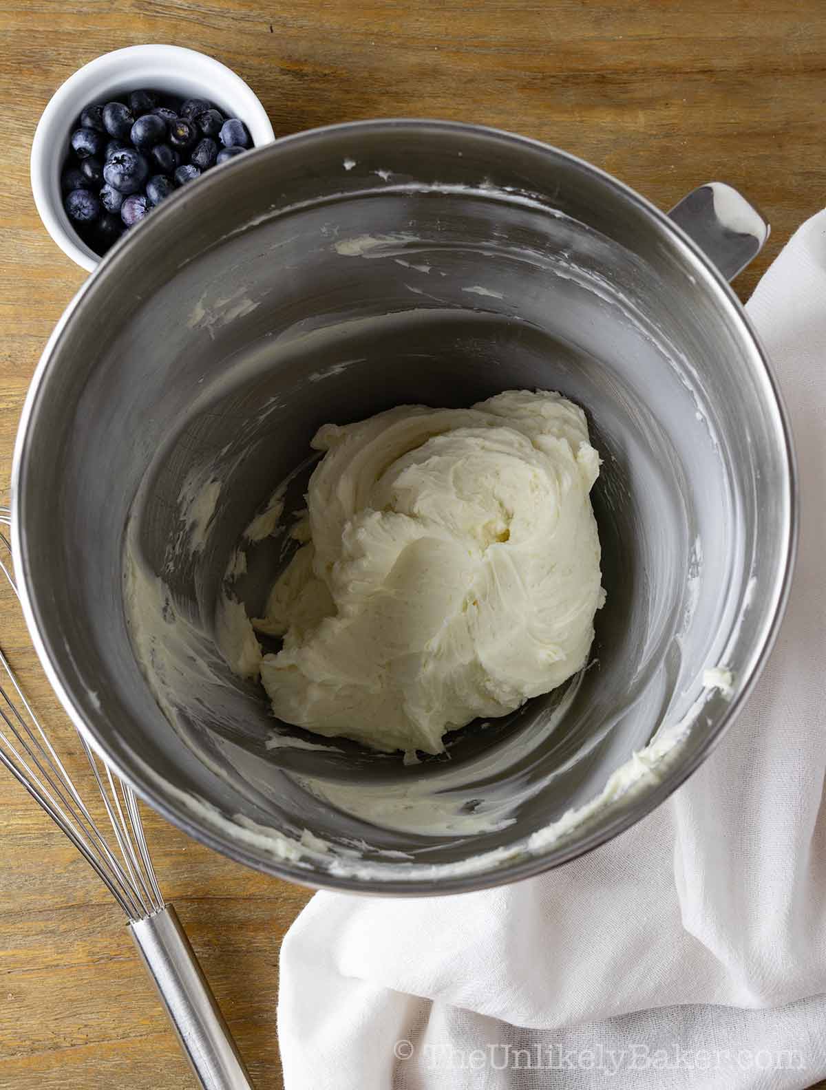 Beaten cream cheese in a bowl.