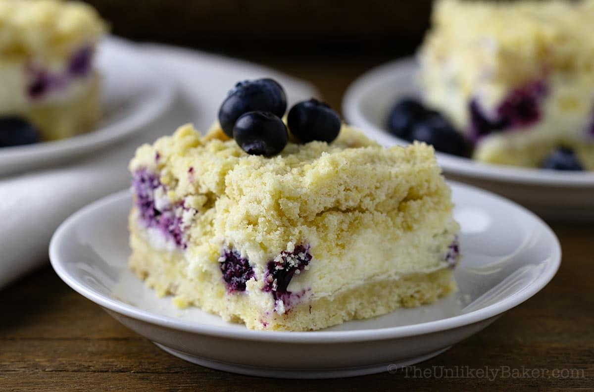 A slice of cream cheese blueberry bars.