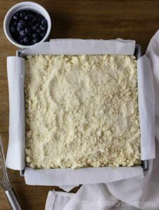 Shortbread crumble on top of cheesecake filling.