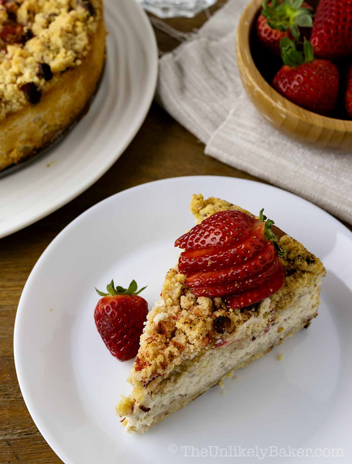 A slice of strawberry crunch cheesecake.