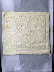 Puff pastry scored with a fork.