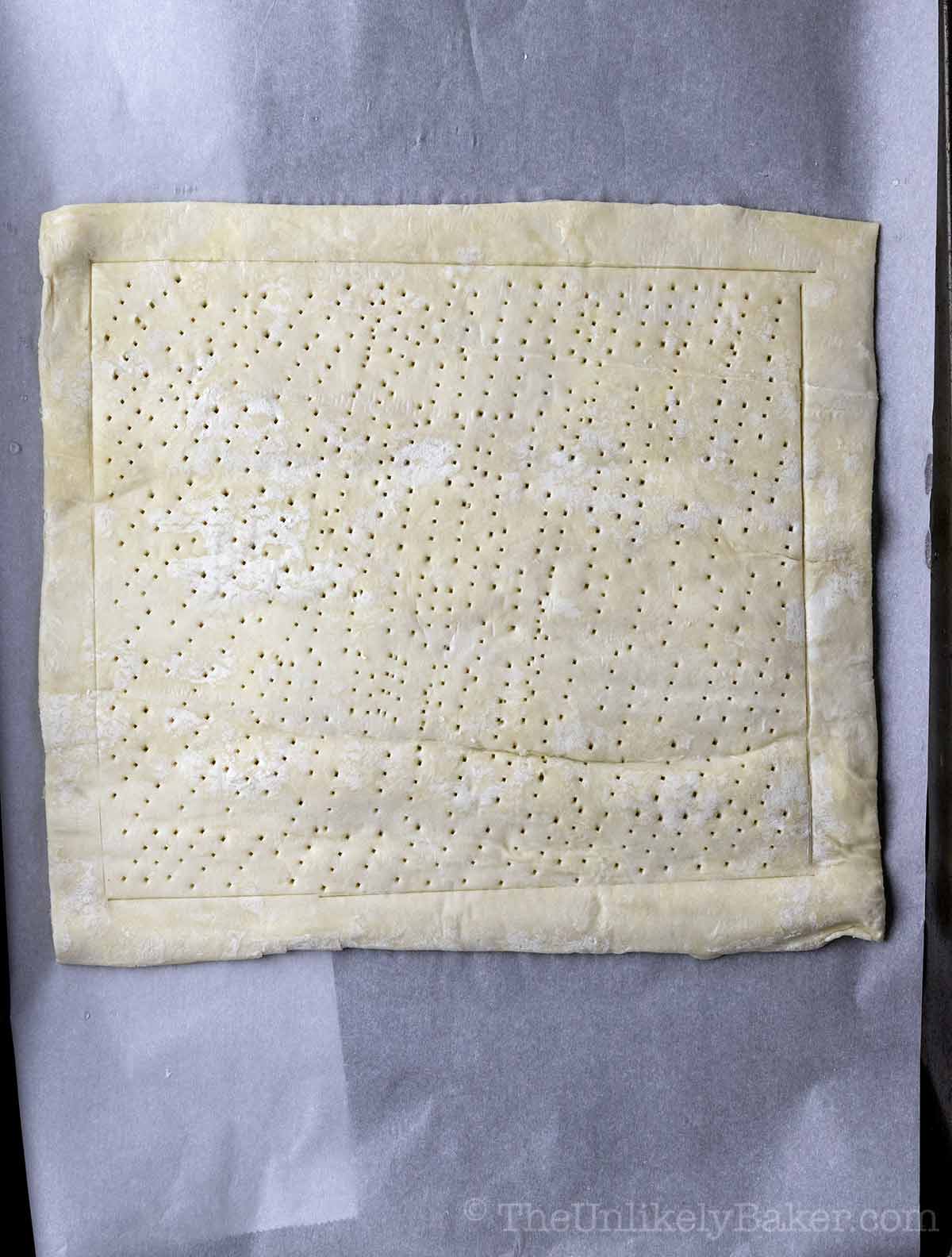 Puff pastry scored with a fork.