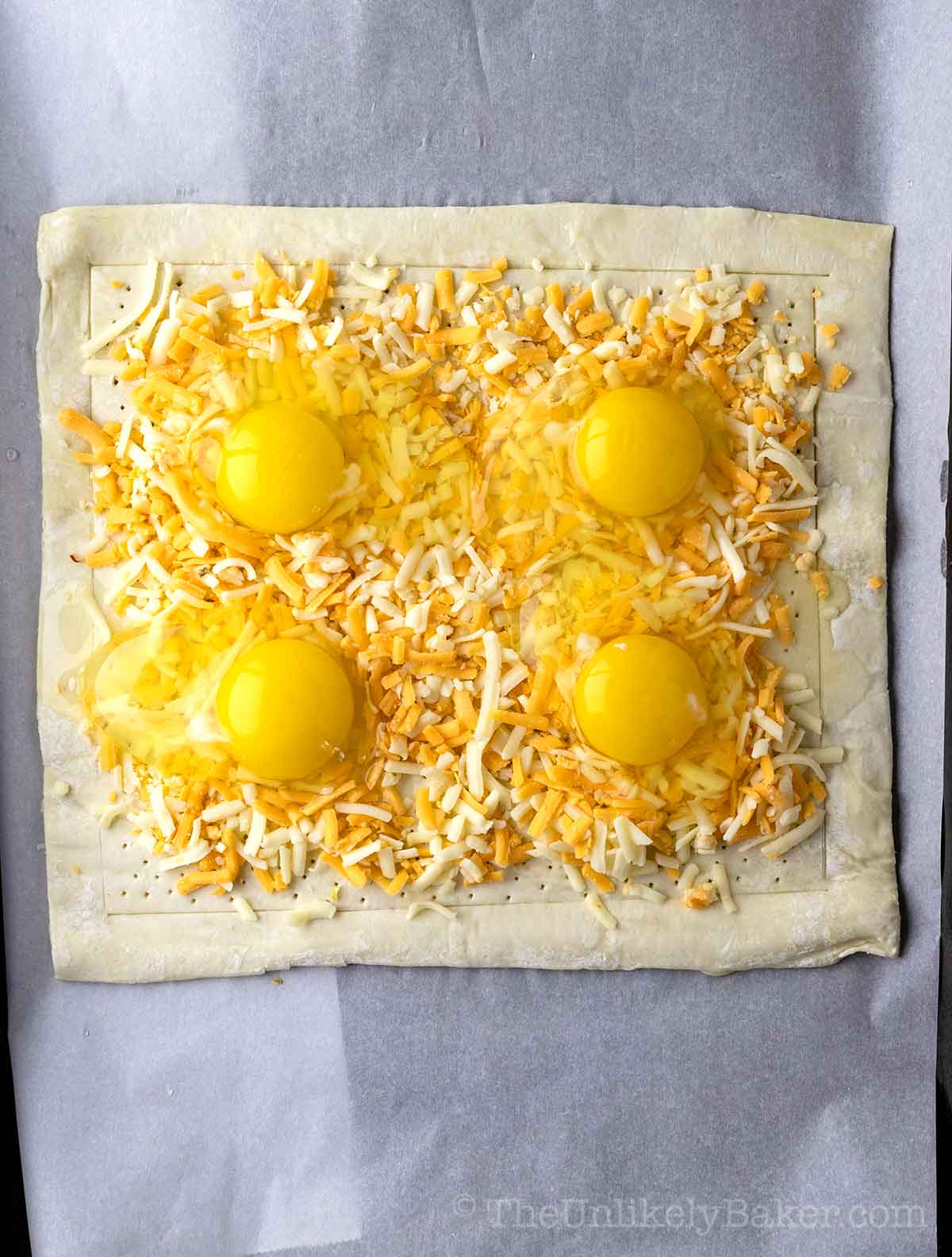 Eggs added to shredded cheese.