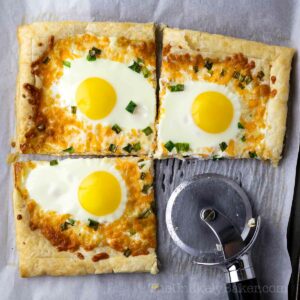 Eggs in puff pastry sliced with a pizza cutter.