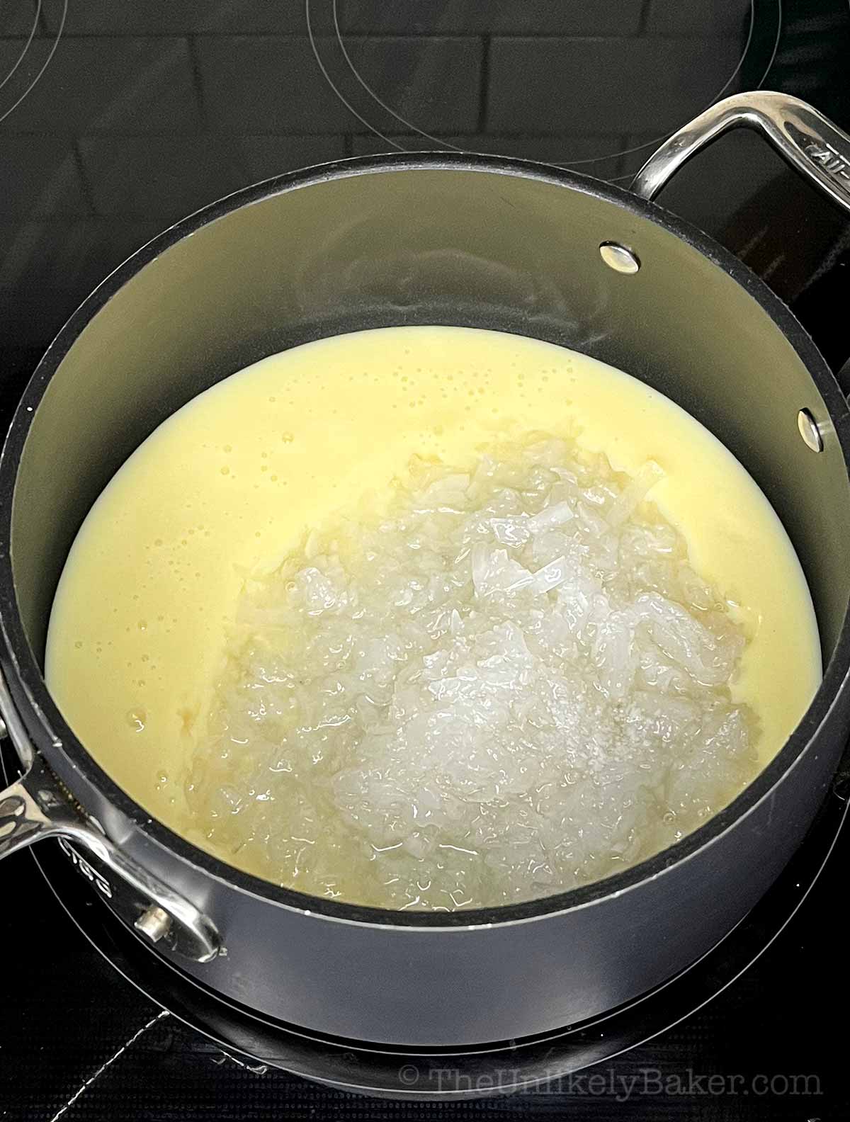 Macapuno and condensed milk in a pan.