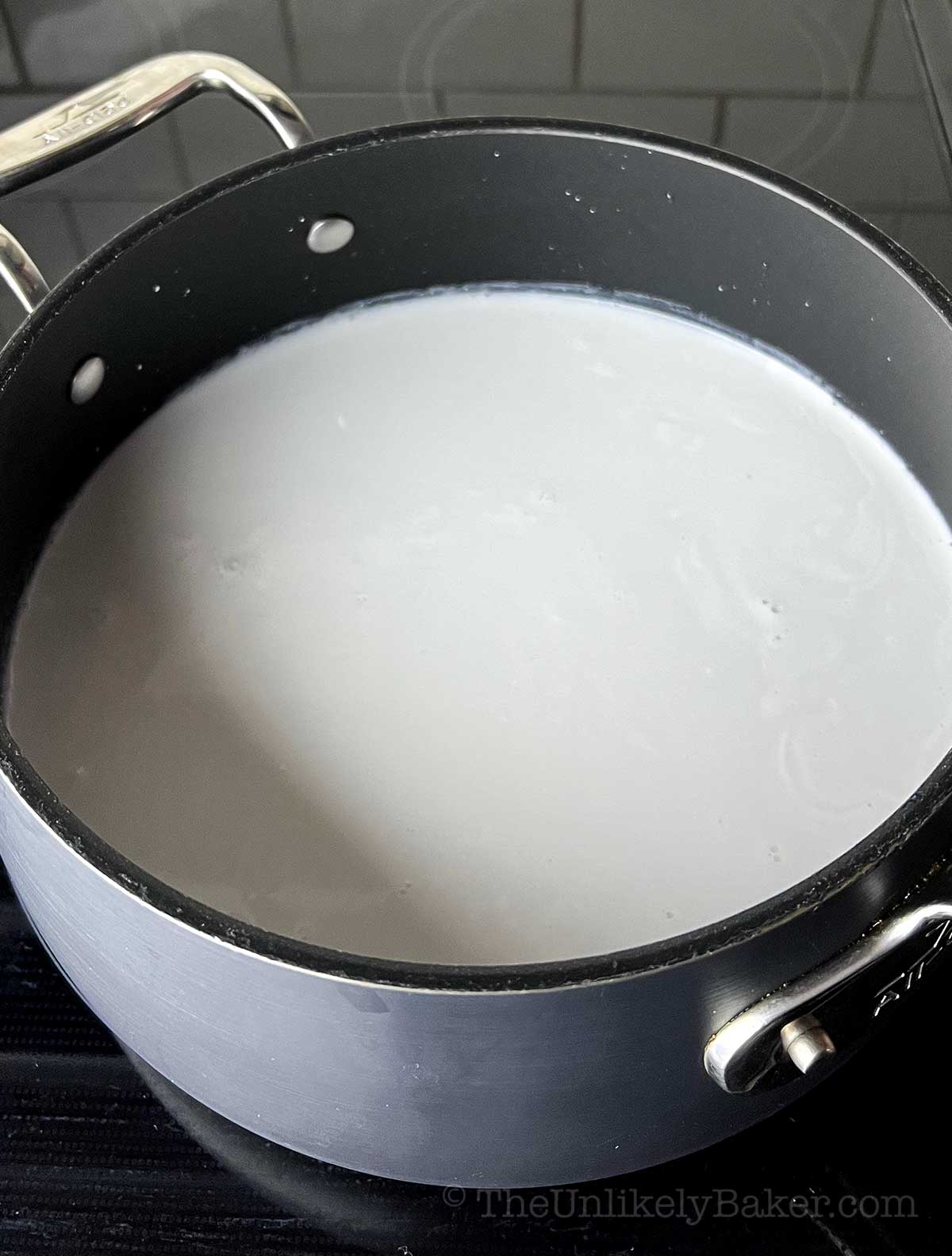 Coconut milk and sticky rice in a pot.