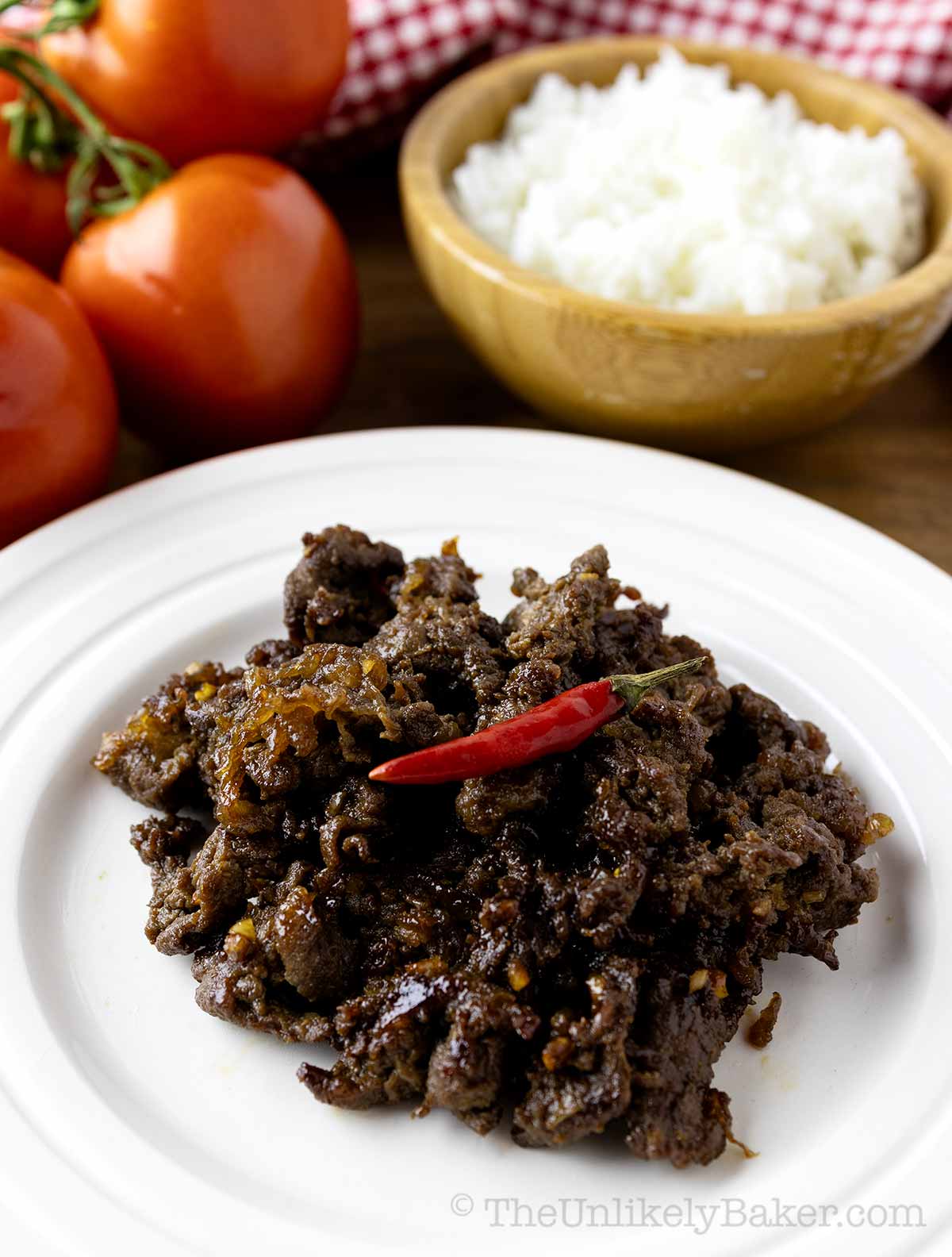 Beef tapa with a chili on top.