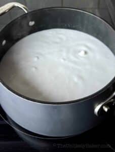 Coconut milk boiling in a pot.