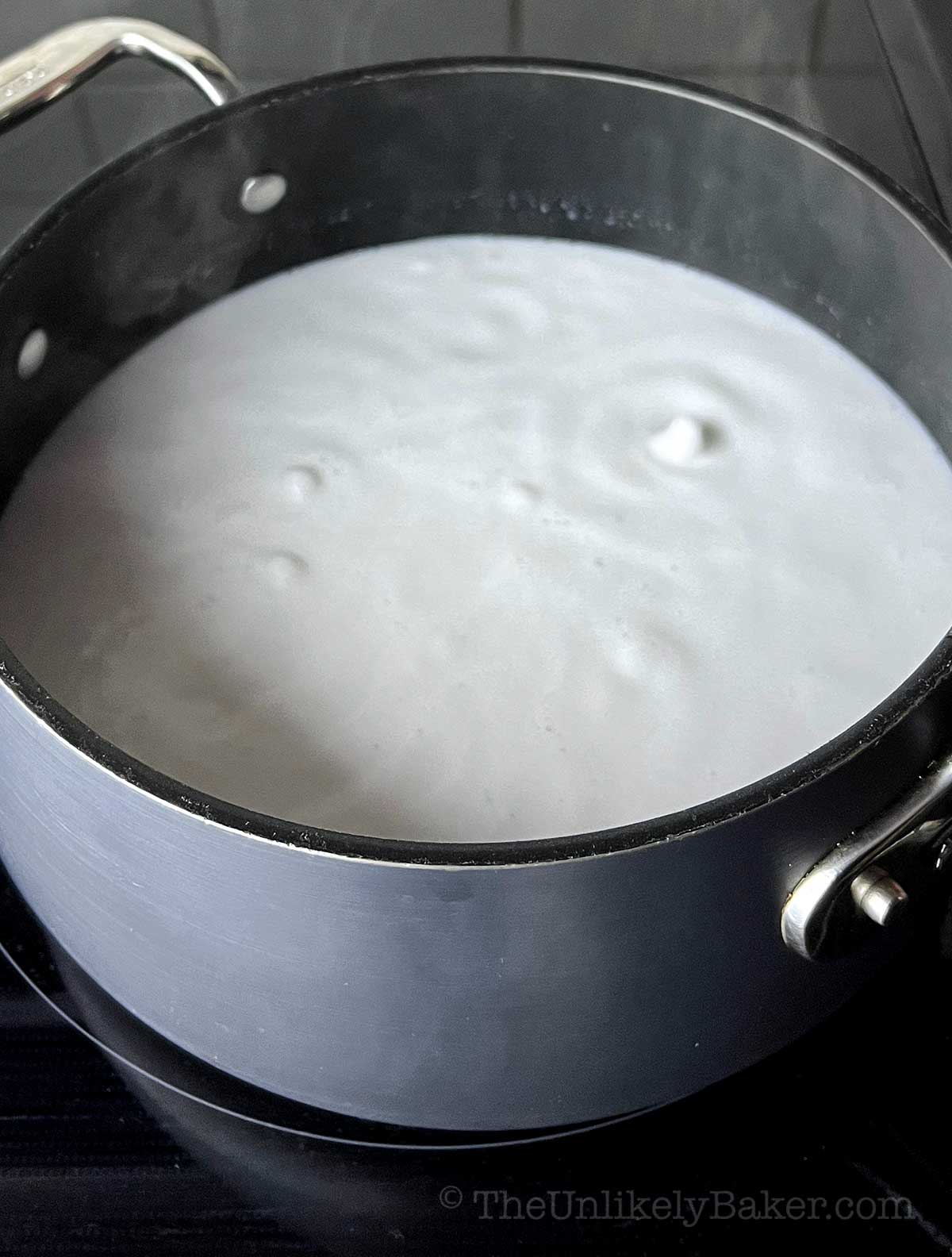 Coconut milk boiling in a pot.