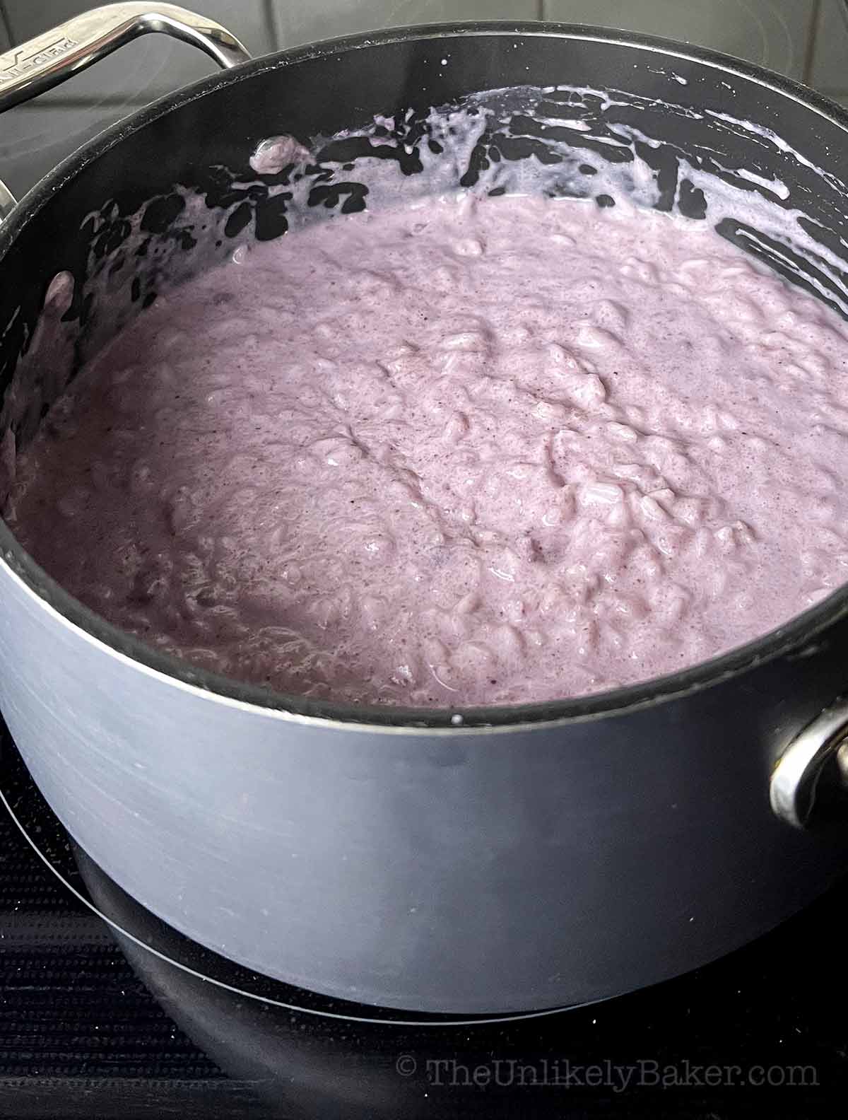 Ube champorado made with ube powder in a pot.