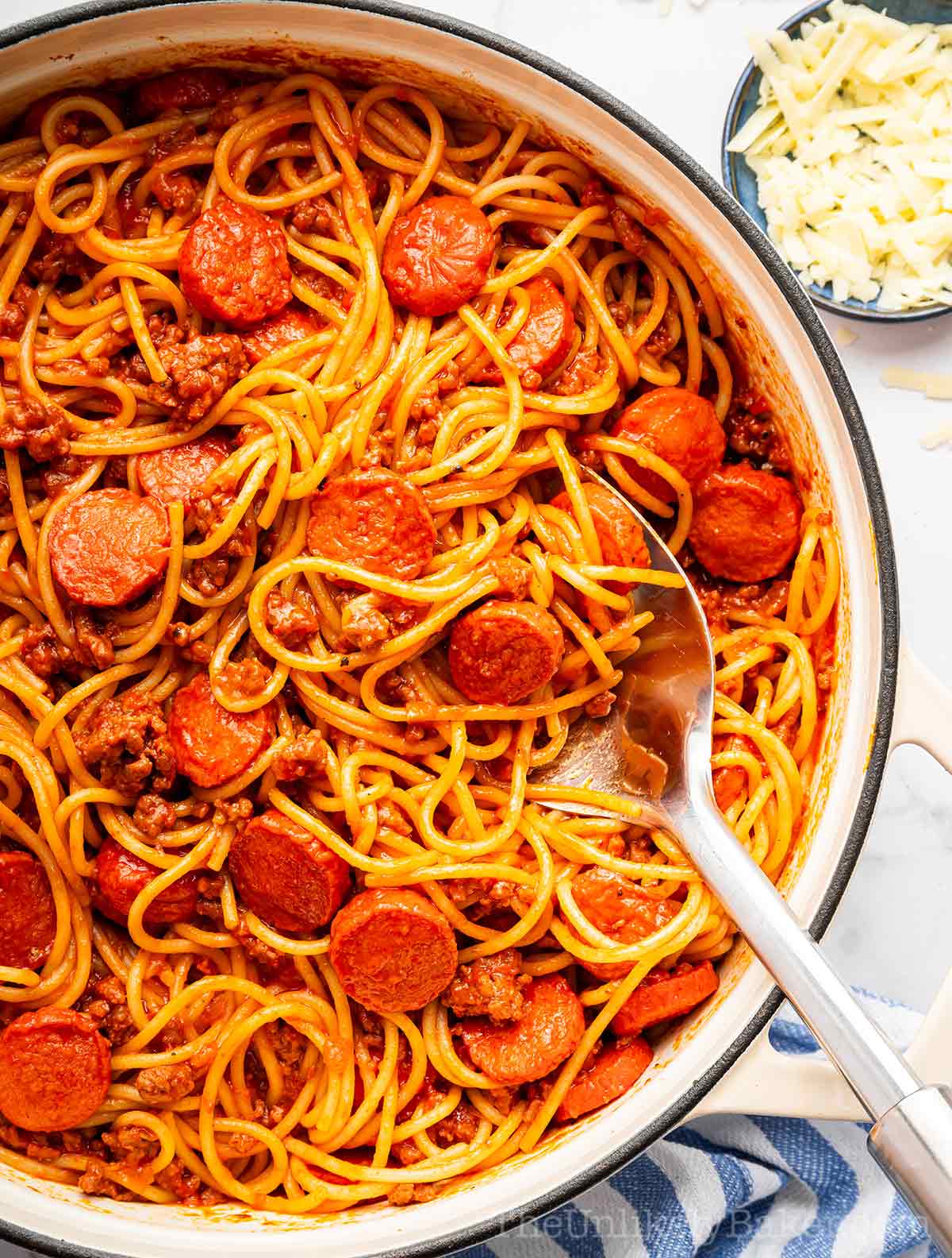 Filipino style spaghetti with hotdogs in a pan.