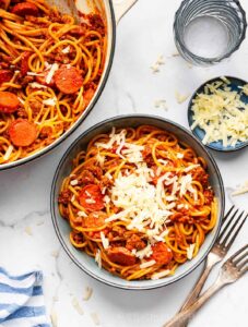 Overhead shot of Filipino spaghetti with cheddar cheese.