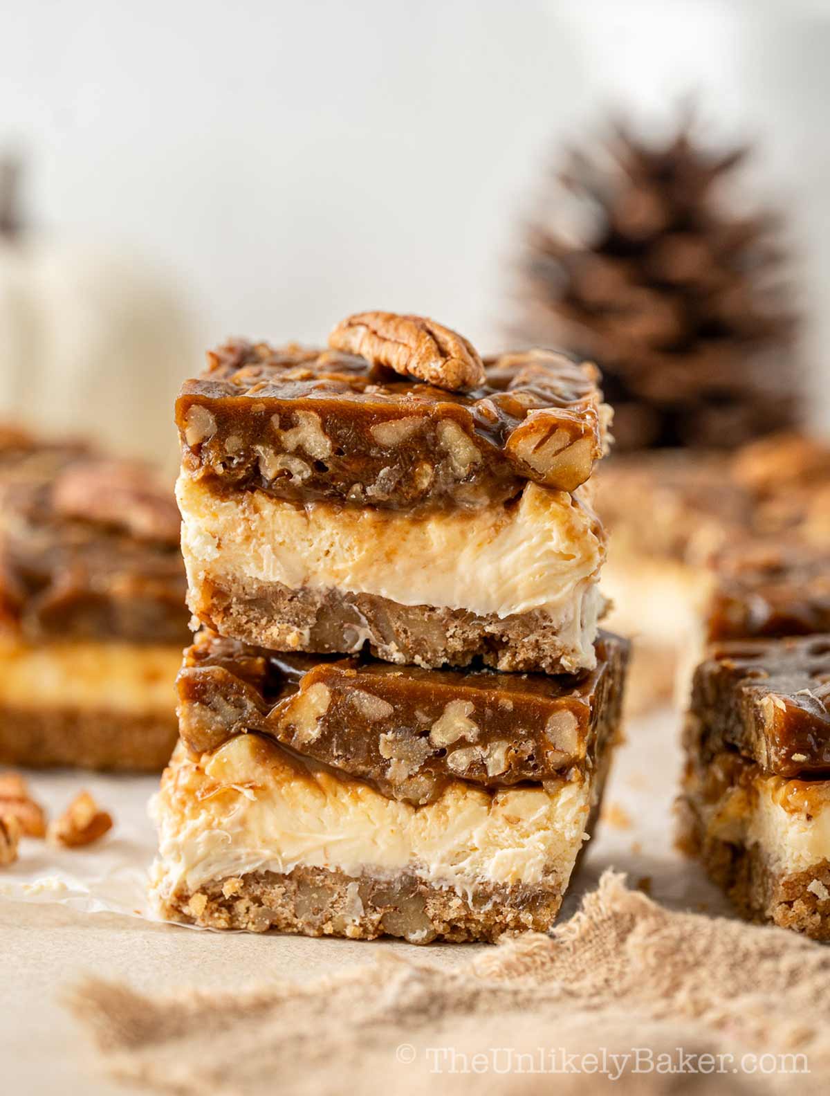 A stack of butter pecan cheesecake bars.