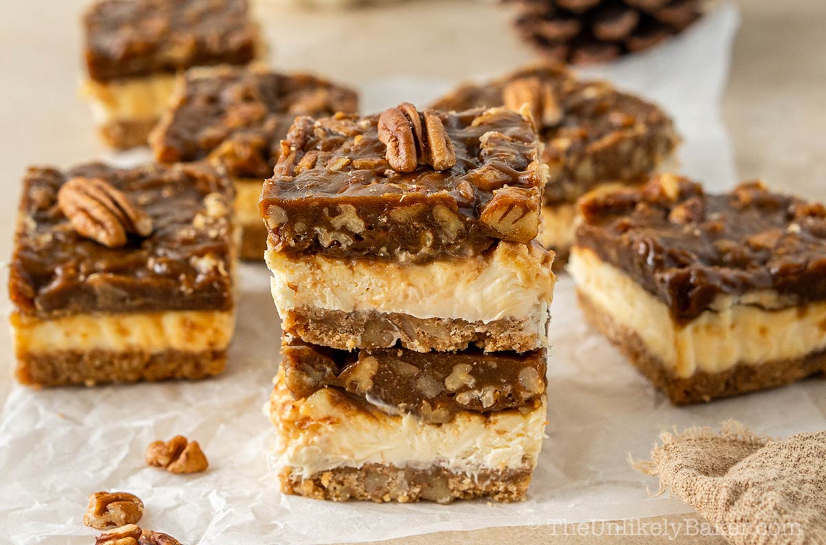 A stack of pecan pie cheesecake bars.
