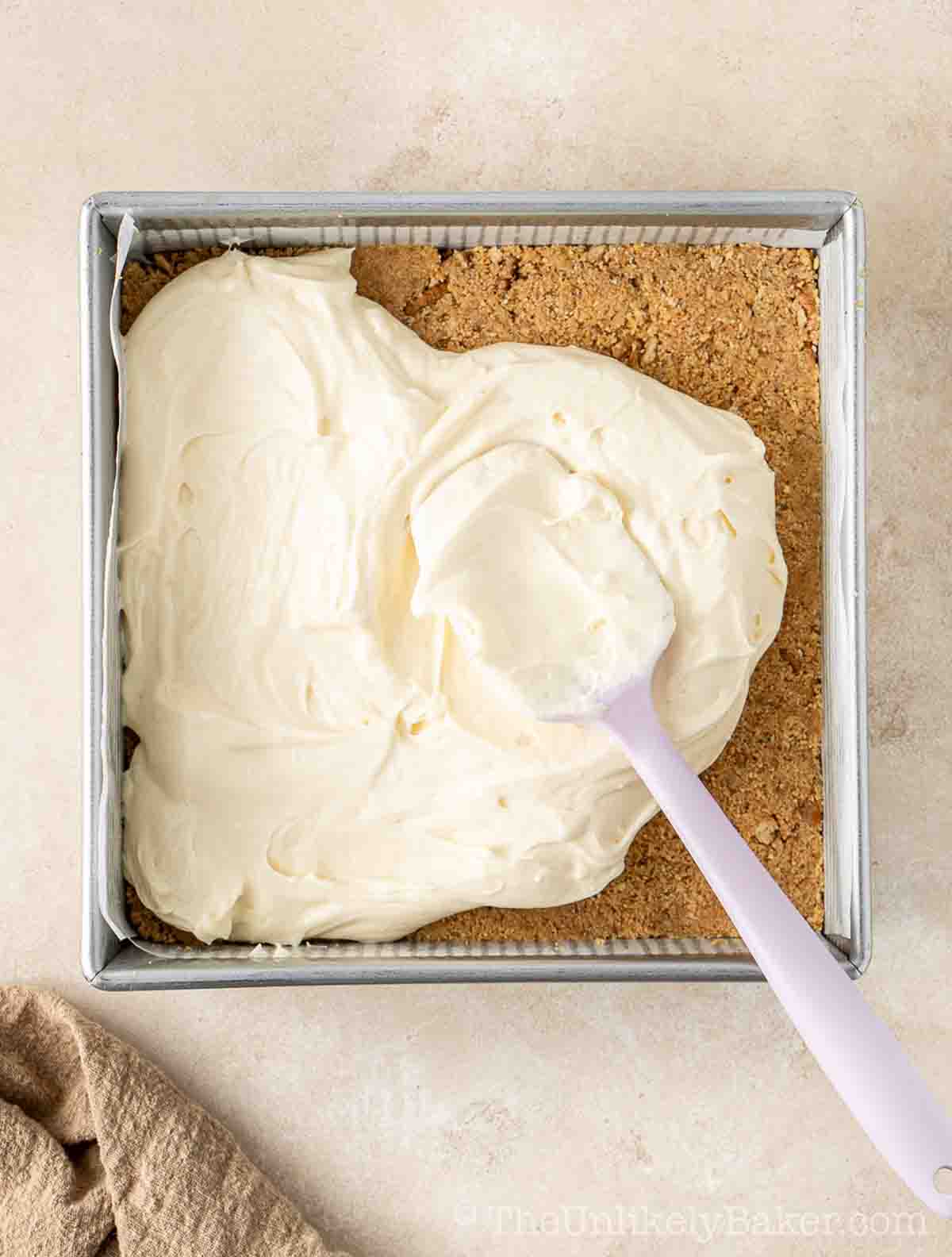 Cheesecake batter transfered to pan.