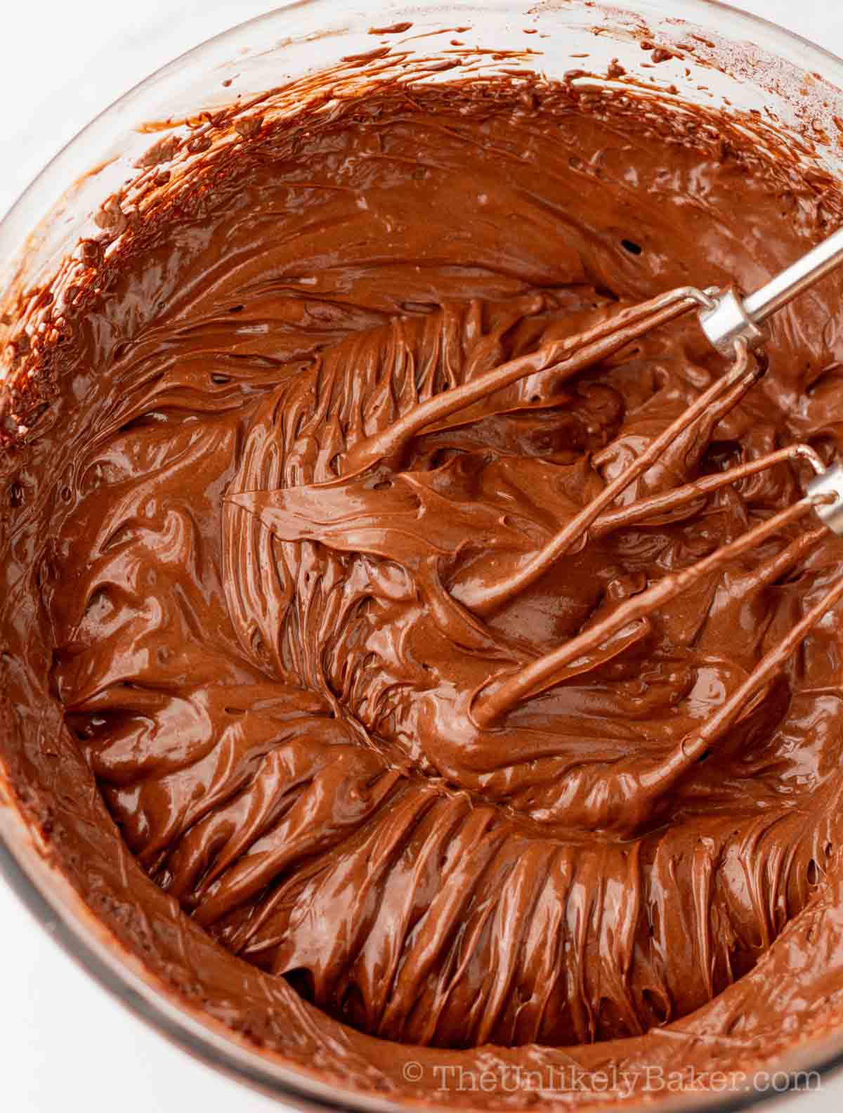 Smooth and creamy chocolate fudge frosting in a bowl.
