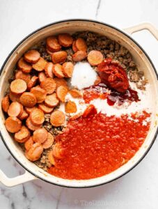 Tomato sauce and cream added to meat.