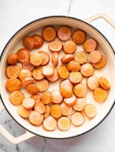 Cooked hotdogs in a pan.