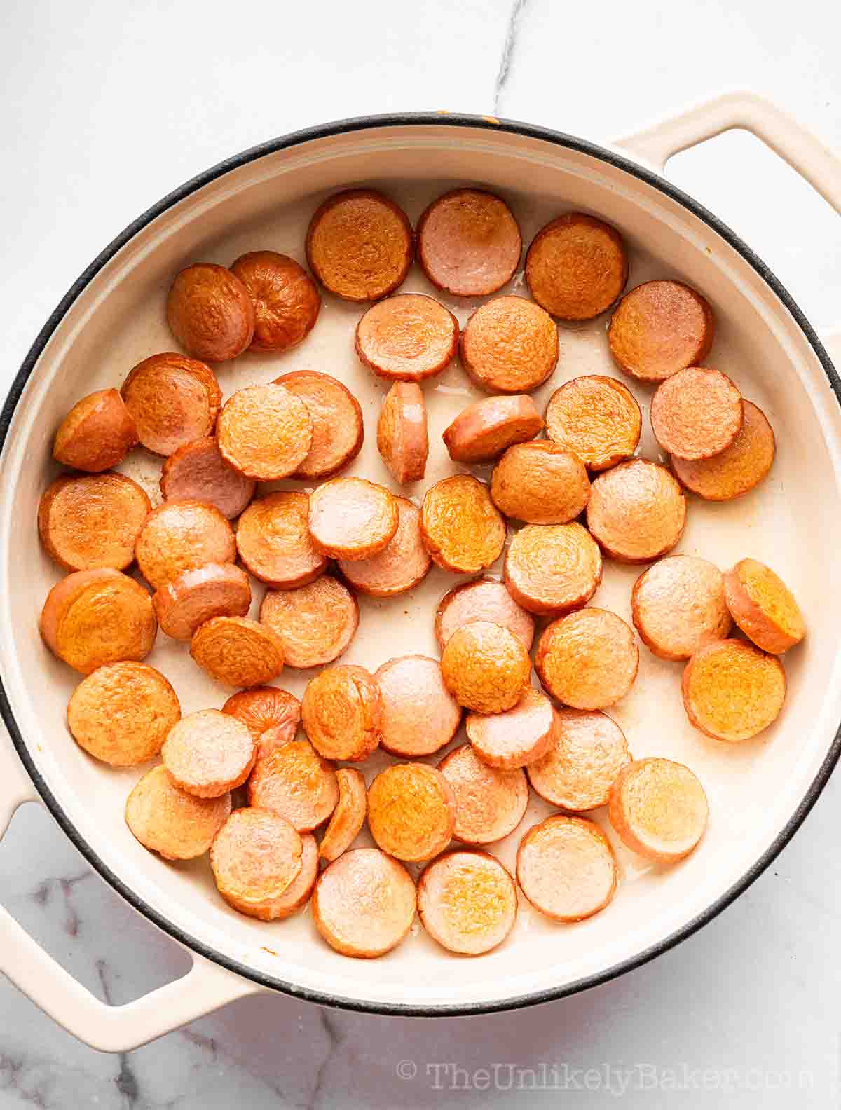 Cooked hotdogs in a pan.