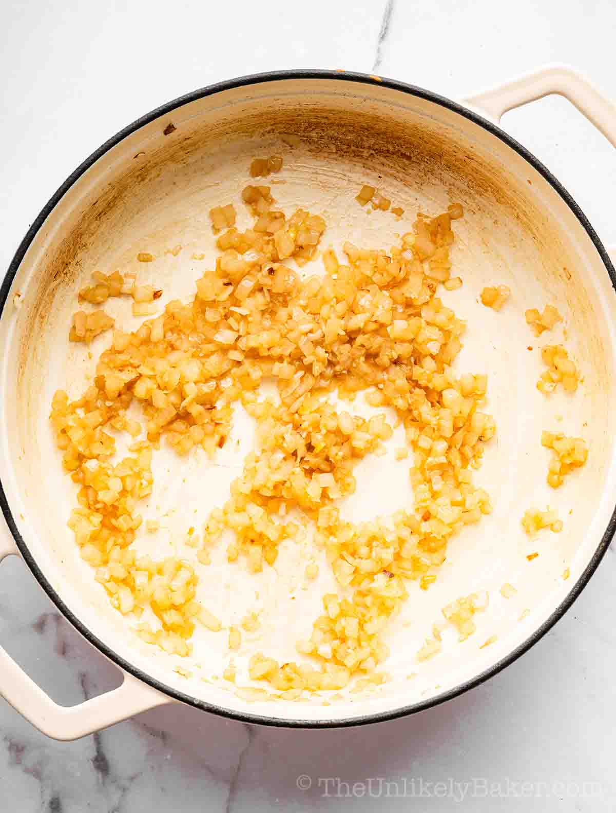 Garlic and onions sautéed in a pan.