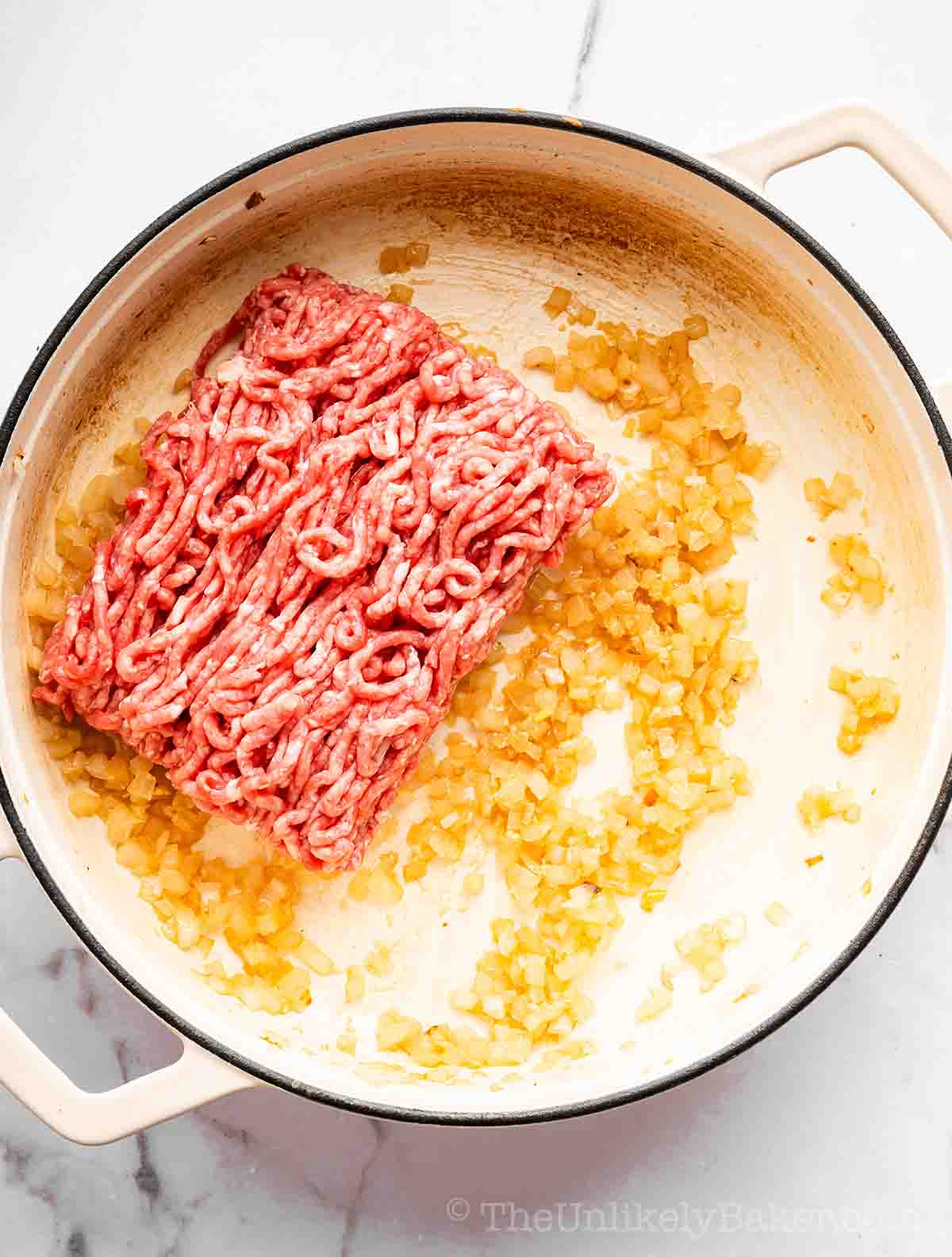 Ground beef added to sautéed aromatics.