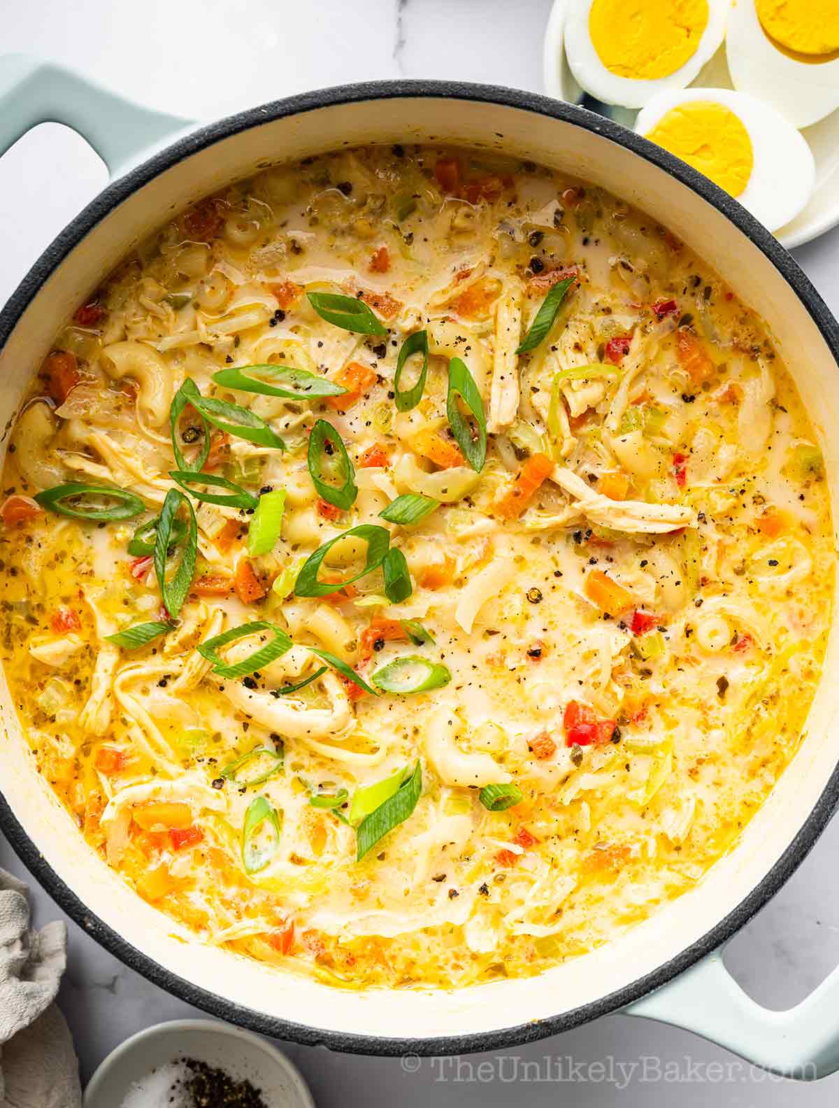 Filipino chicken sopas topped with green onions.