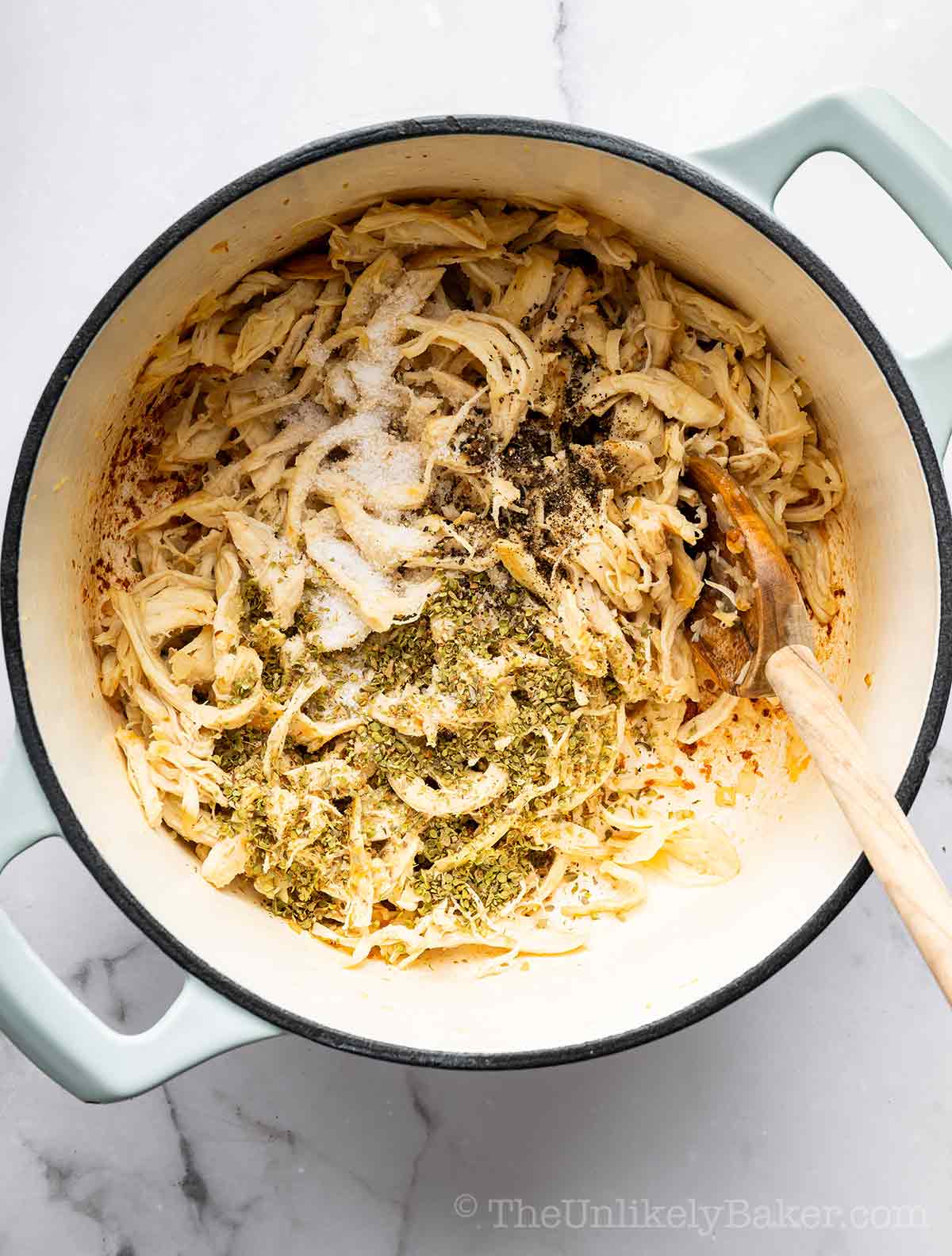 Chicken and spices in a pot.