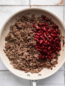 Kidney beans and ground beef in a pan.