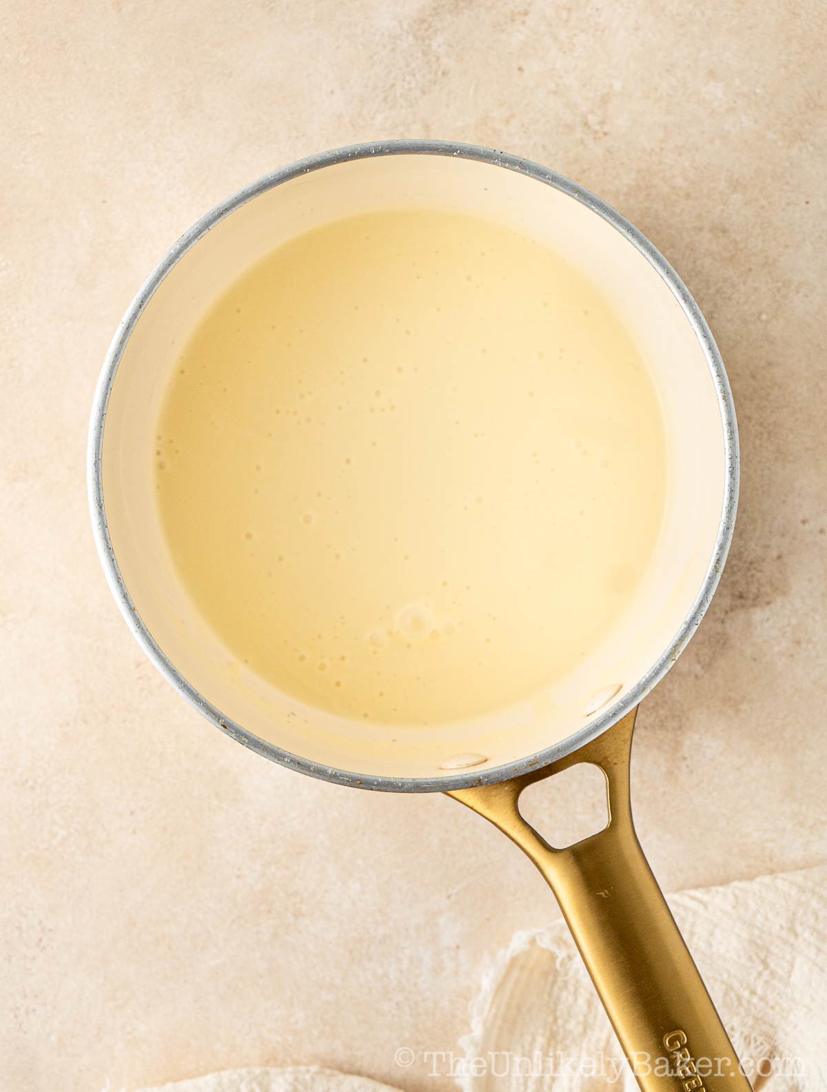 Warm cream in a pot.