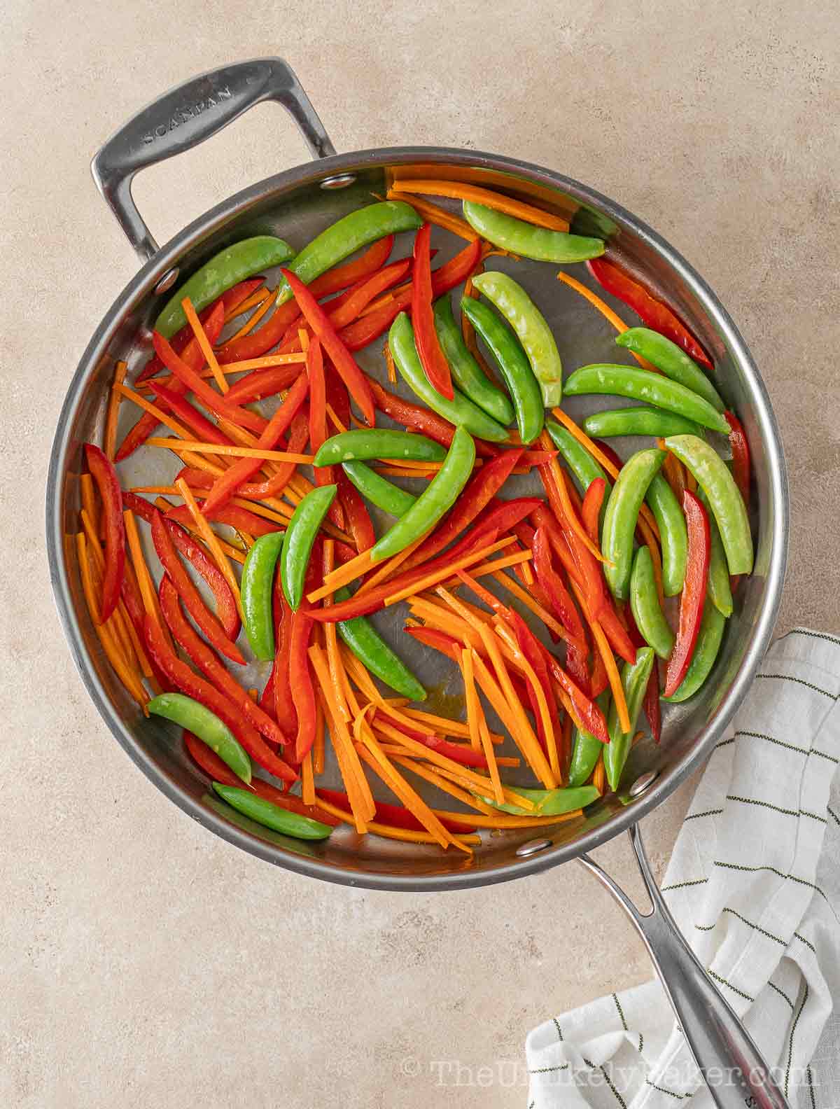 Vegetables cooking in pan.