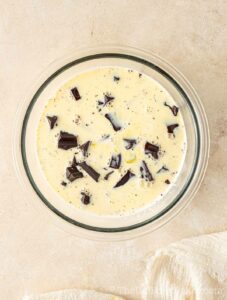 Cream poured over chopped chocolate.