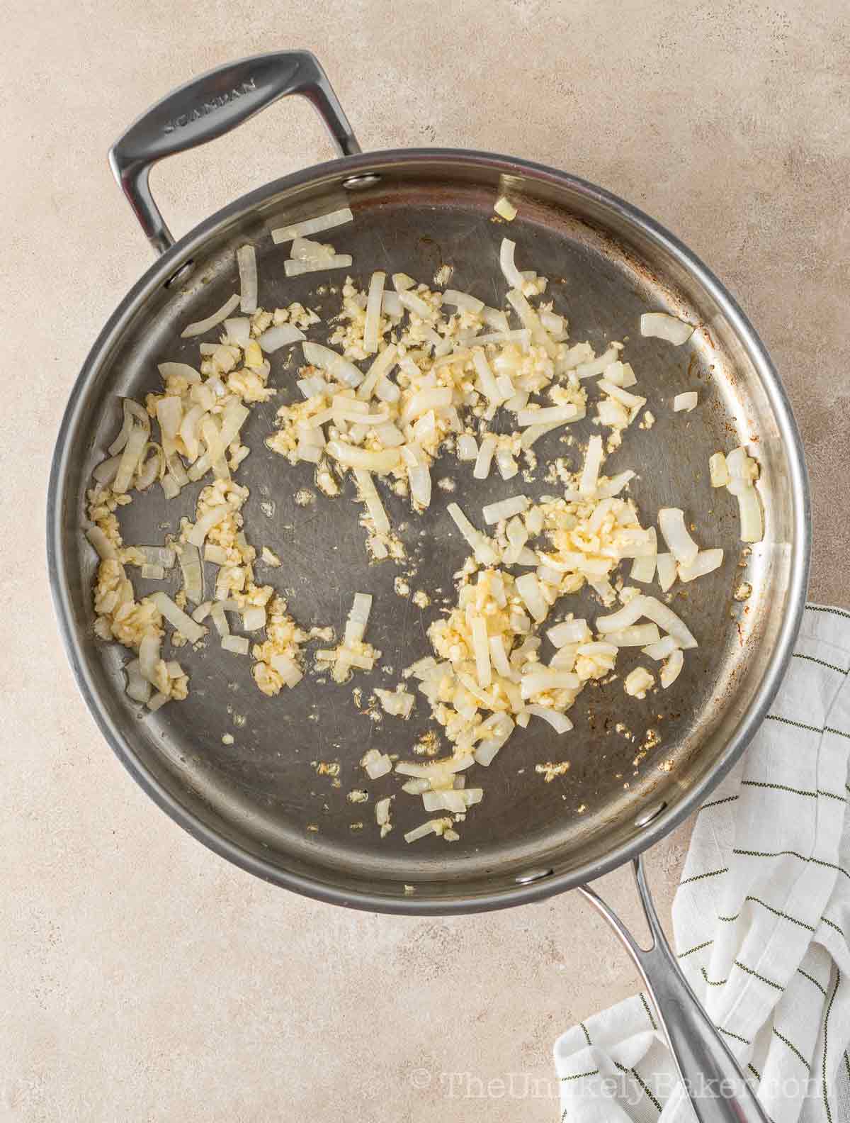 Onions and garlic saut&eacute;ing in pan.