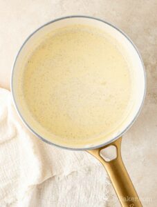 Heavy cream and vanilla paste in a pan.